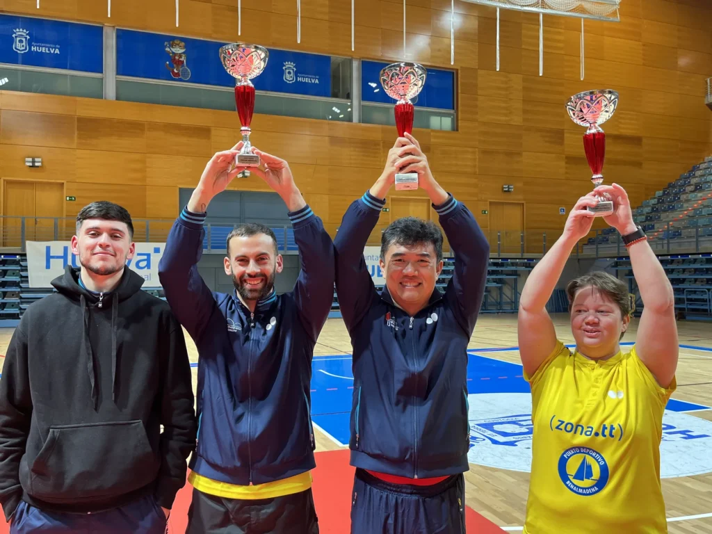 Cuatro personas con trofeos felices.